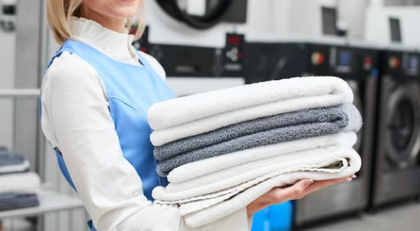 portrait-laundry-worker-background-clothes-hangers-dry-cleaning_154092-5785