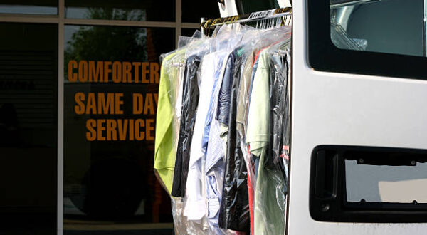 Drycleaned clothing hanging on van rack outside drycleaning shopSimilar: